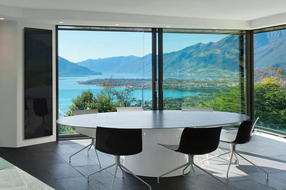 Glass panel in an open-plan room with full-height glazing — exactly where heat loss is highest and sizing matters most.