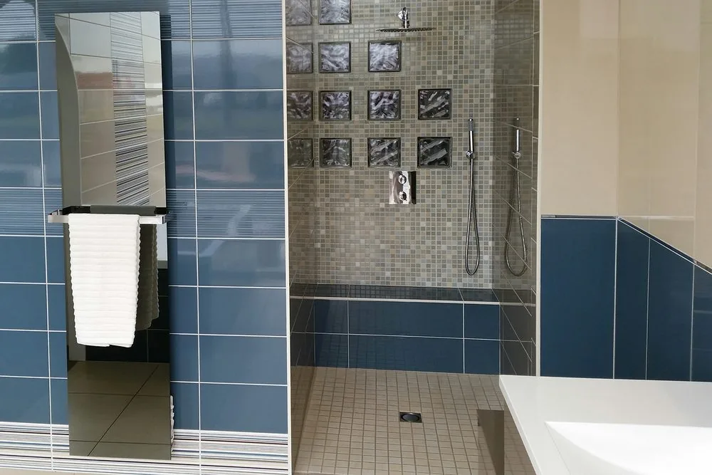 The mirror version. Its surface runs warmer than the room, so it resists fogging — it replaces a mirror you were fitting anyway.