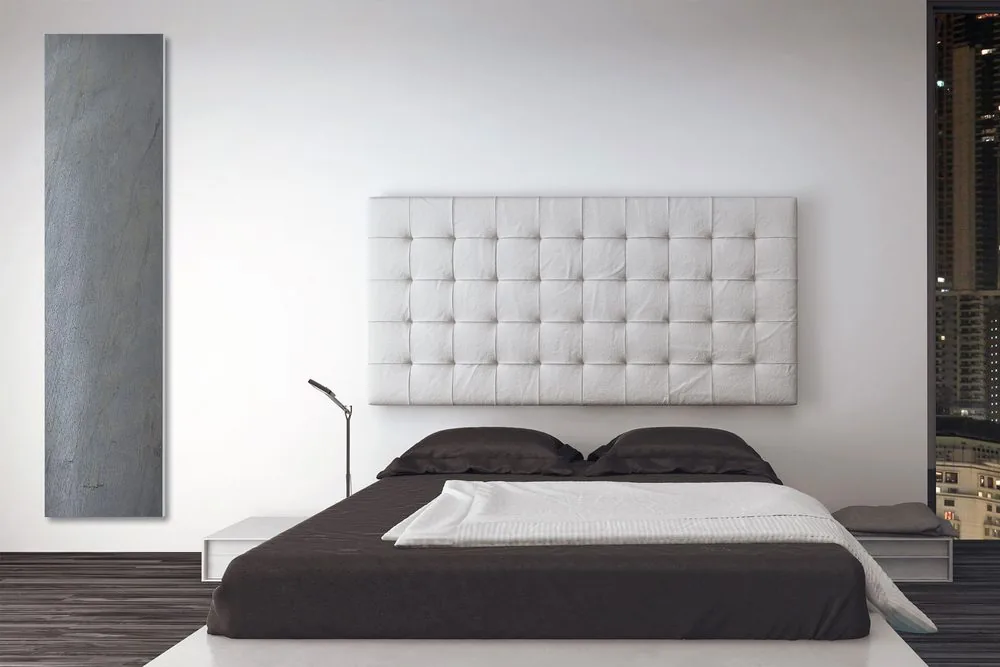 A stone panel set beside the bed. Radiant warmth at low surface temperature is what makes this comfortable to sleep next to.