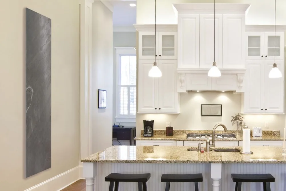 Graphite stone in a kitchen — a slim vertical panel takes wall height where floor and counter space are already committed.