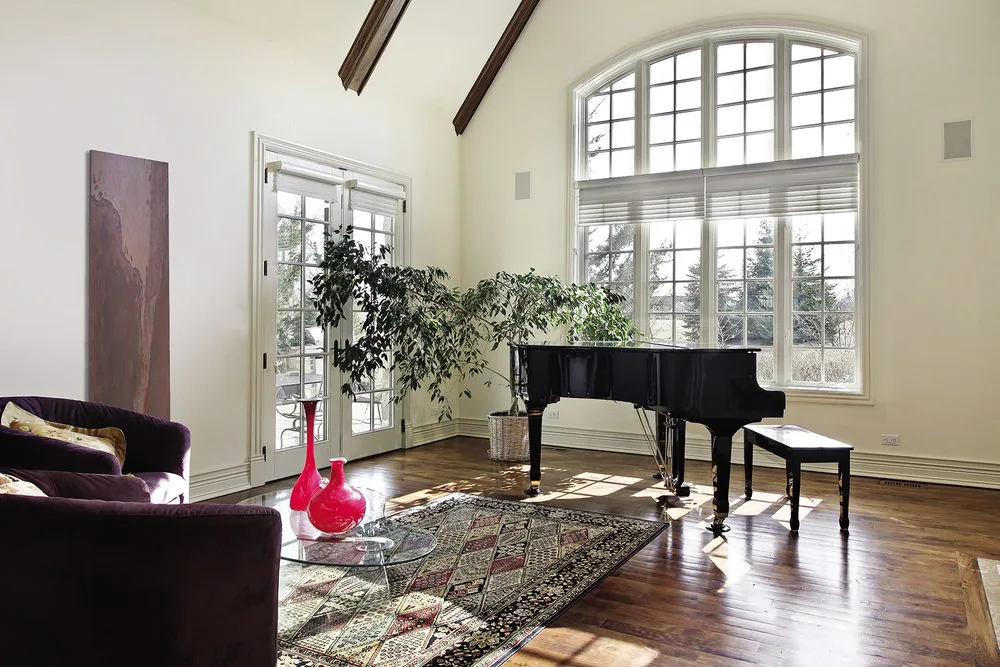 Natural stone in a double-height living room. At this scale the panel works as a wall finish, not a heater.